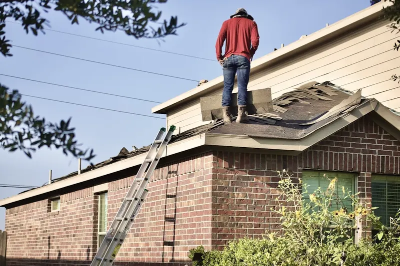 Professional roofer working on a residential roof in Pinefield